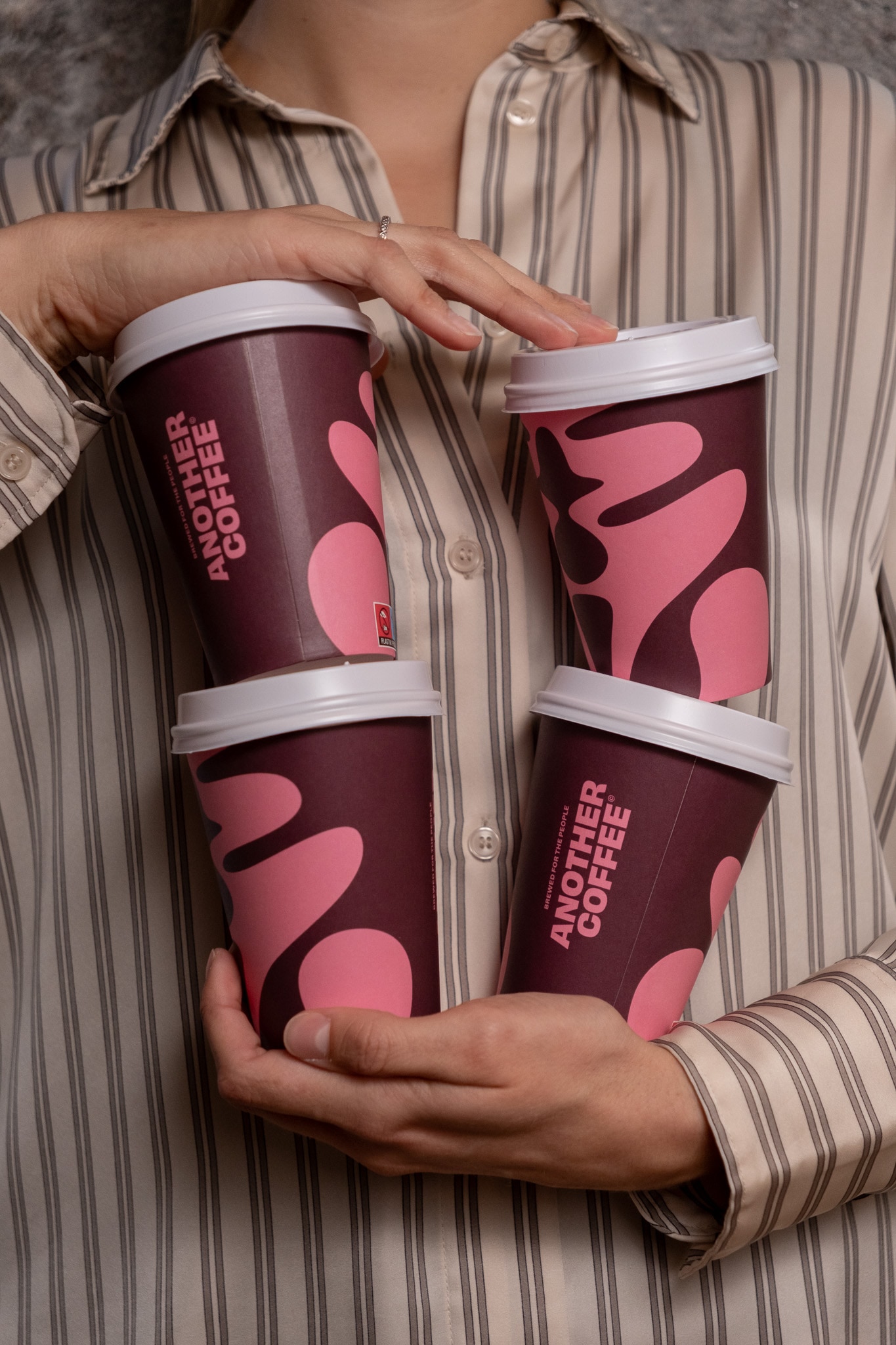Four Another Coffee cups in hand