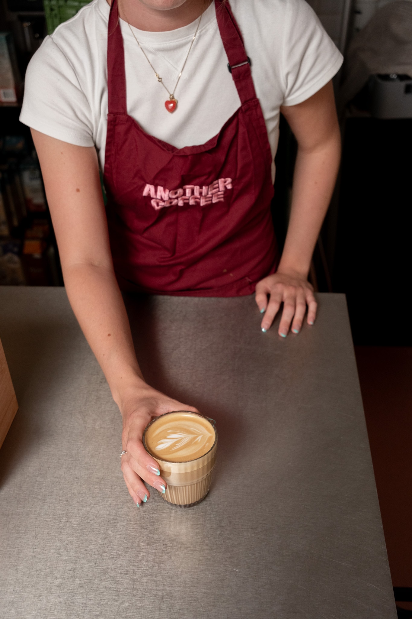 Coffee handed across the counter at Another Coffee
